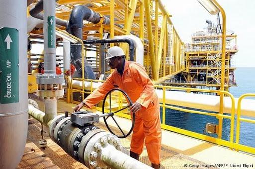 Technician working on oil production infrastructure